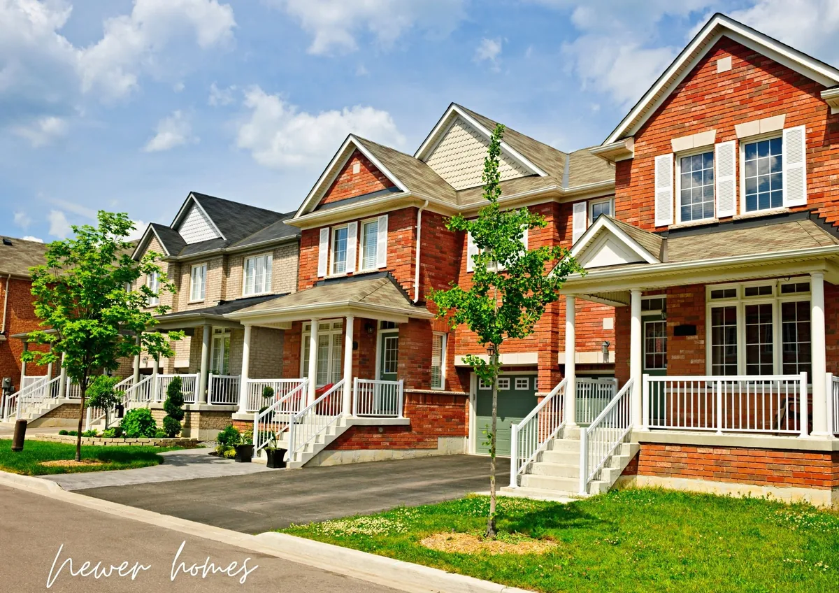 Row of newer brick homes with front porches and young street trees